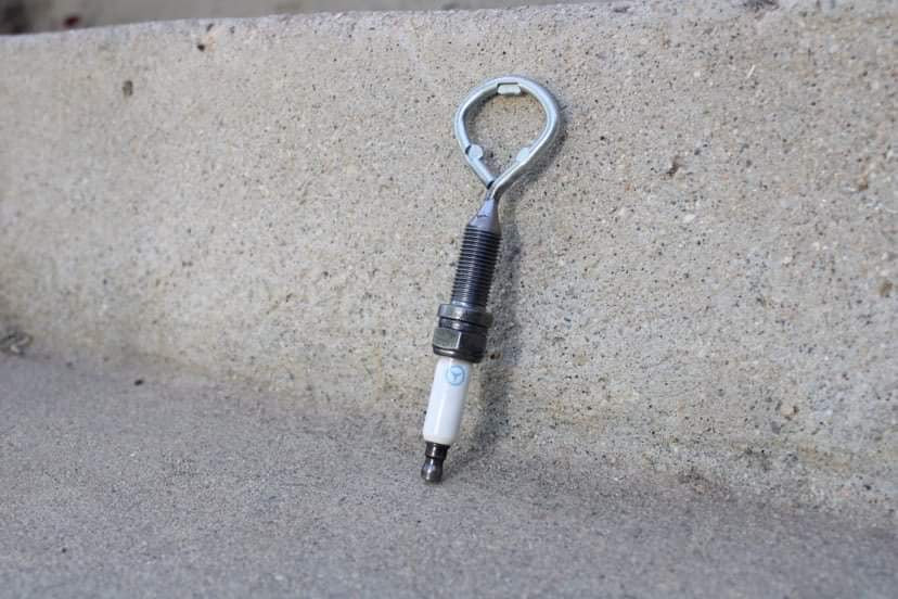Spark plug bottle opener